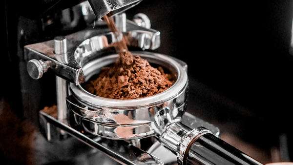 coffee grinder grinding into a portafilter
