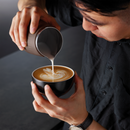 barista making latte art with the breville the Pro Control Jug™