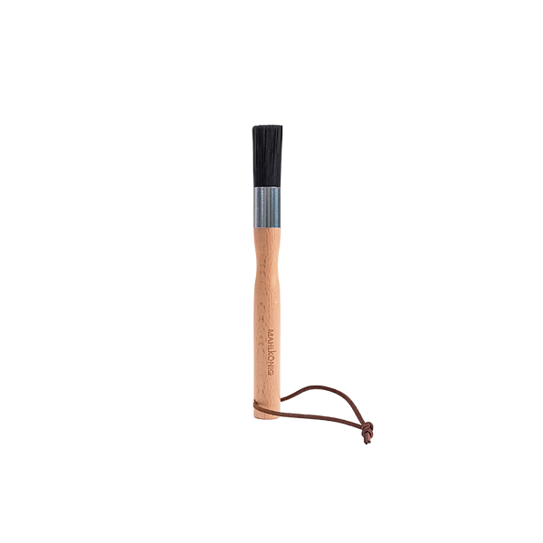 Wooden brush with black bristle head on a white background