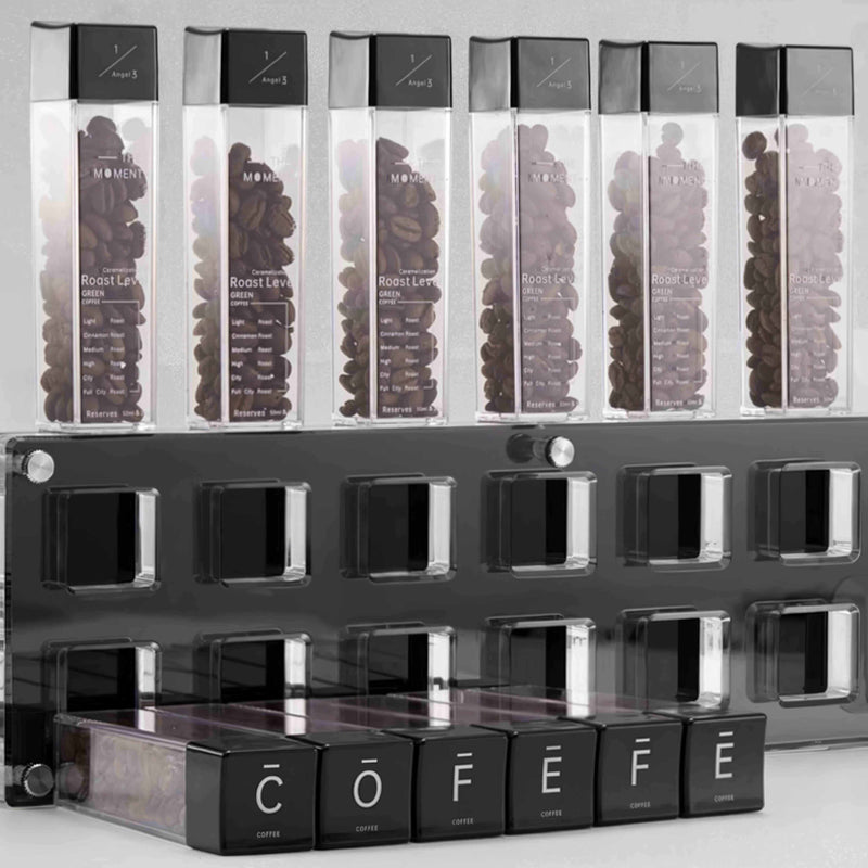 Display of coffee bean containers with visible brand name on a gray background