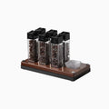 Set of spice containers on a wooden stand with a white background