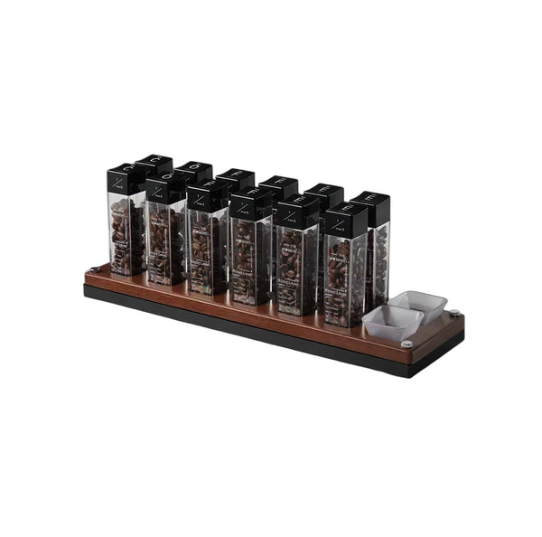 Set of coffee pods in a wooden holder on a white background