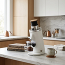 Turin DF54 coffee grinder in a modern kitchen surrounded by coffee books